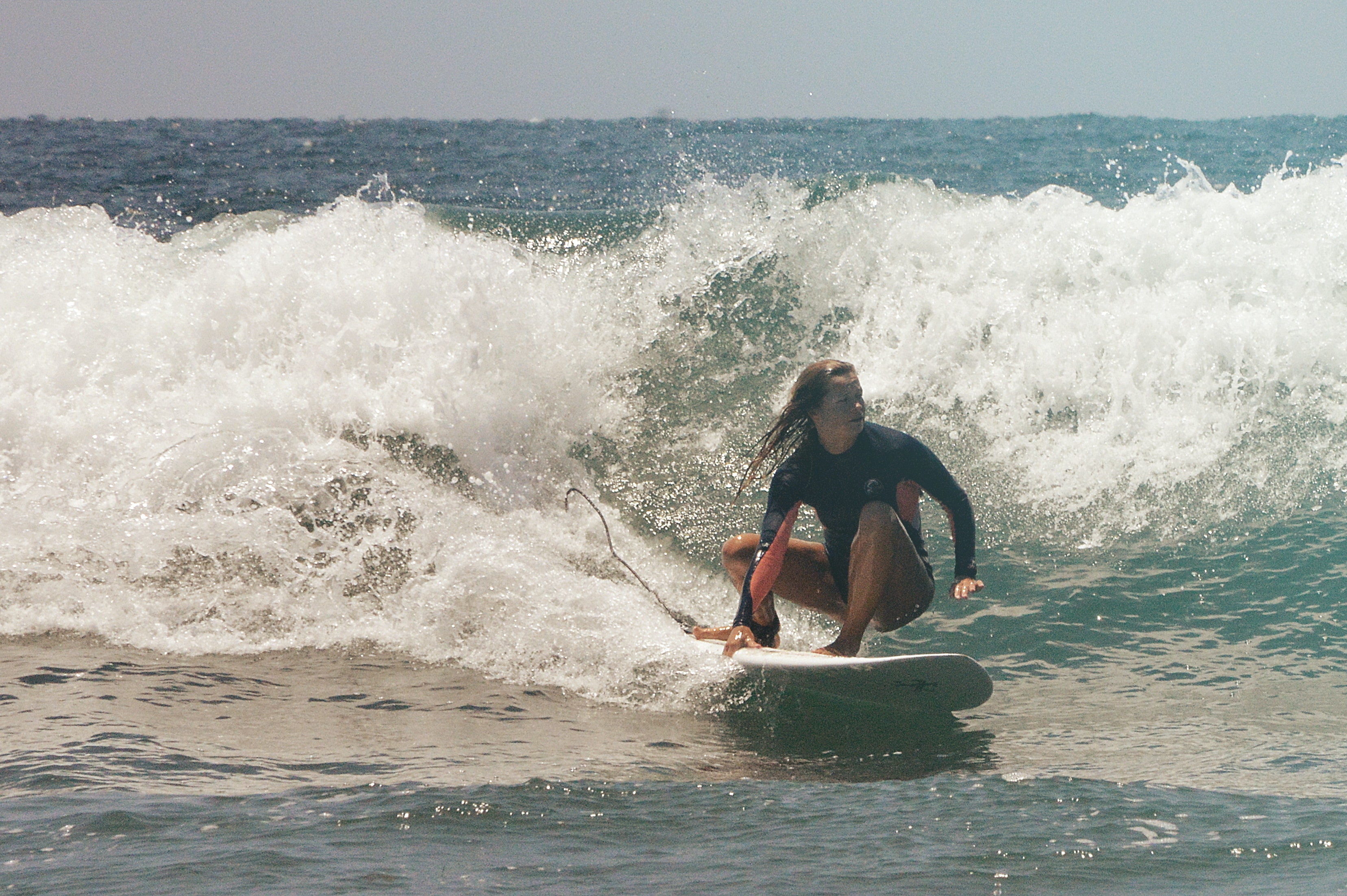 Surfer skillfully riding a large wave, demonstrating patience, resilience, and balance